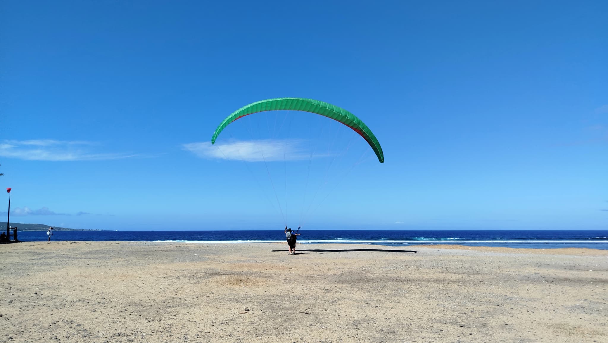 A smooth landing with a paraglider at the edge of the Saint-Leu lagoon, Réunion