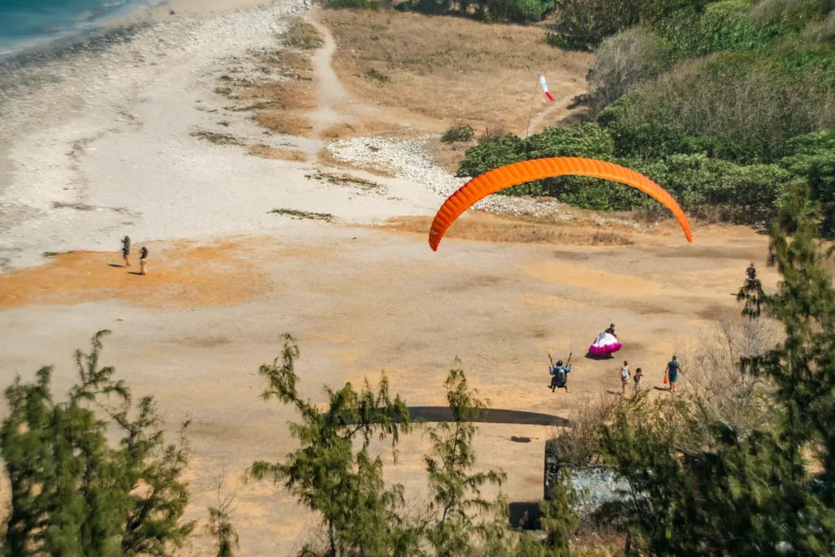 Paragliding landing on Saint-Leu beach at Kélonia, Réunion